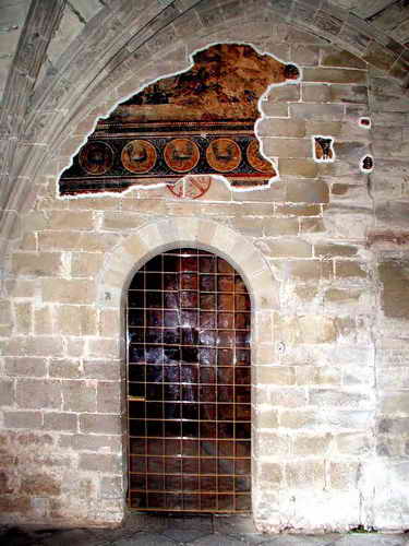 ACCESO AL TEMPLO DESDE LA CAPILLA DE SAN VICTORIAN. RESTOS PICTRICOS Y CRISMN